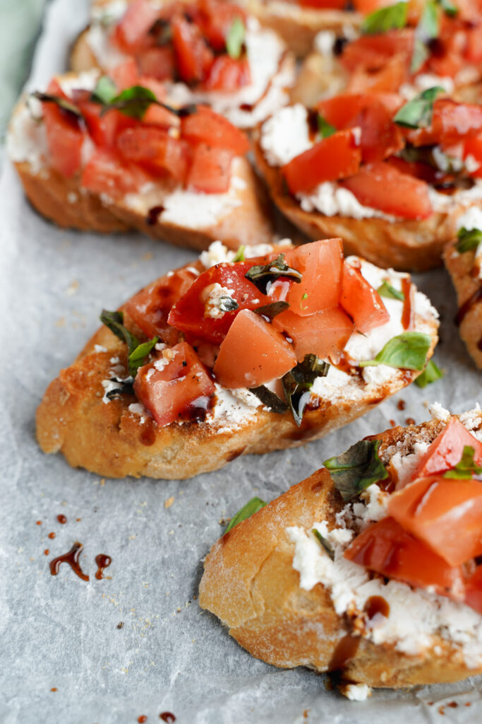 A close up of toasted bread with bruschetta toppings