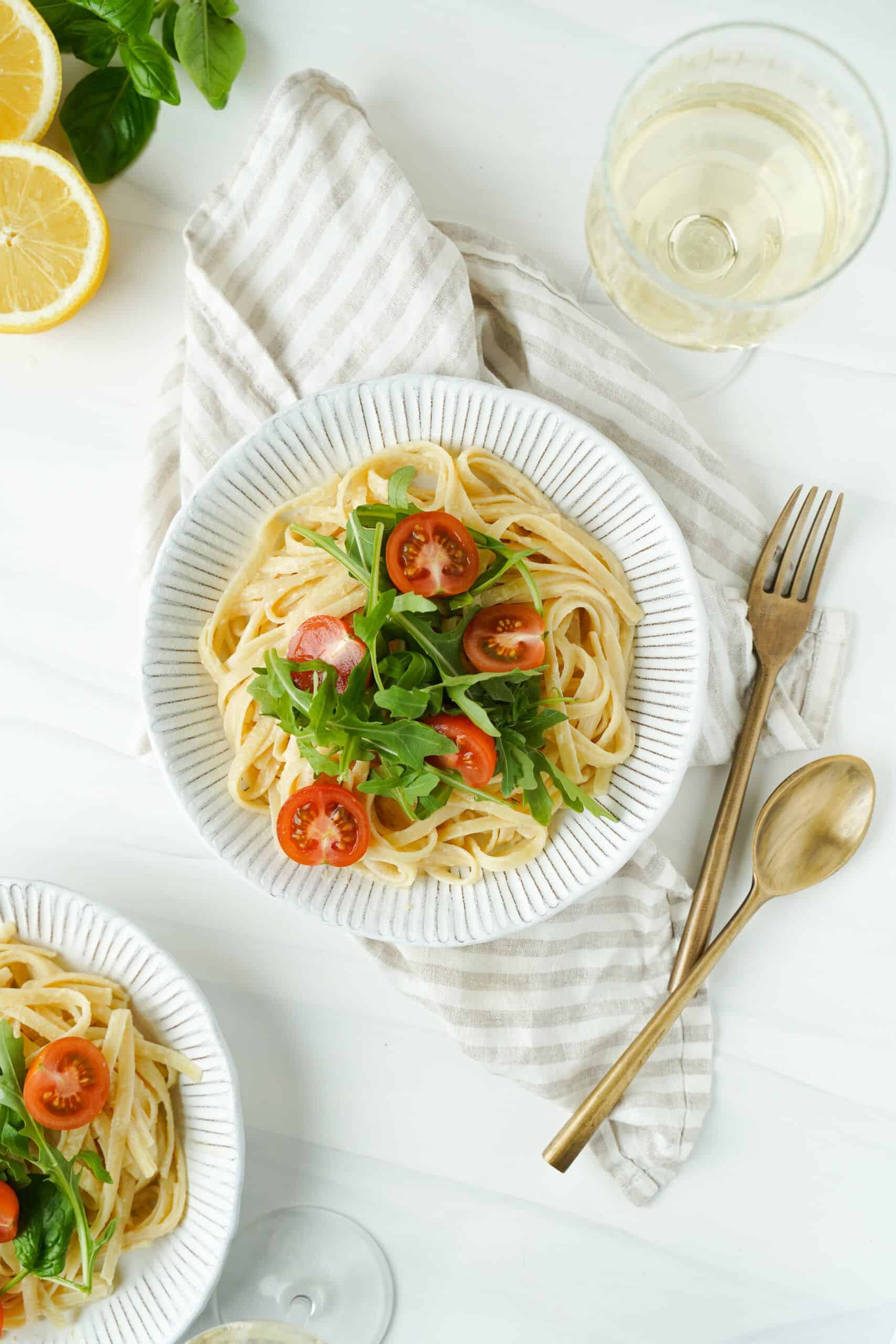 Lemon Pasta topped with cherry tomatoes and fresh basil
