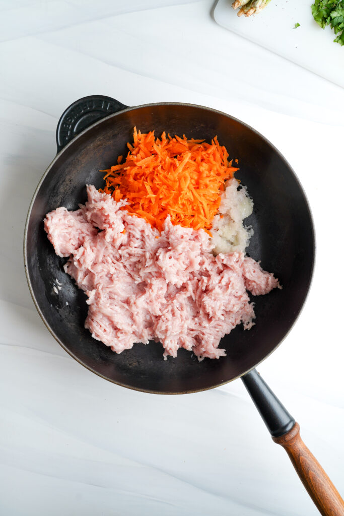 Ground chicken, carrots, and shallots in a large skillet | cookingwithcassandra.com