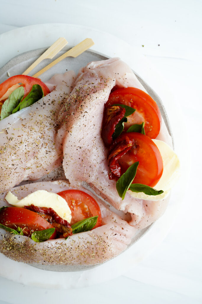 Raw Chicken with seasoning, tomatoes and dried herbs | cookingwithcassandra.com