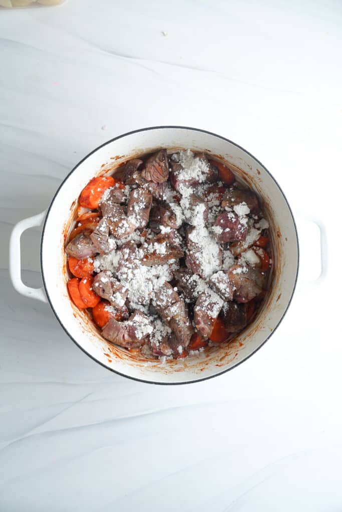 Sprinkle the mixture with all-purpose flour to thicken the sauce for Beef Stew Recipe | cookingwithcassandra.com