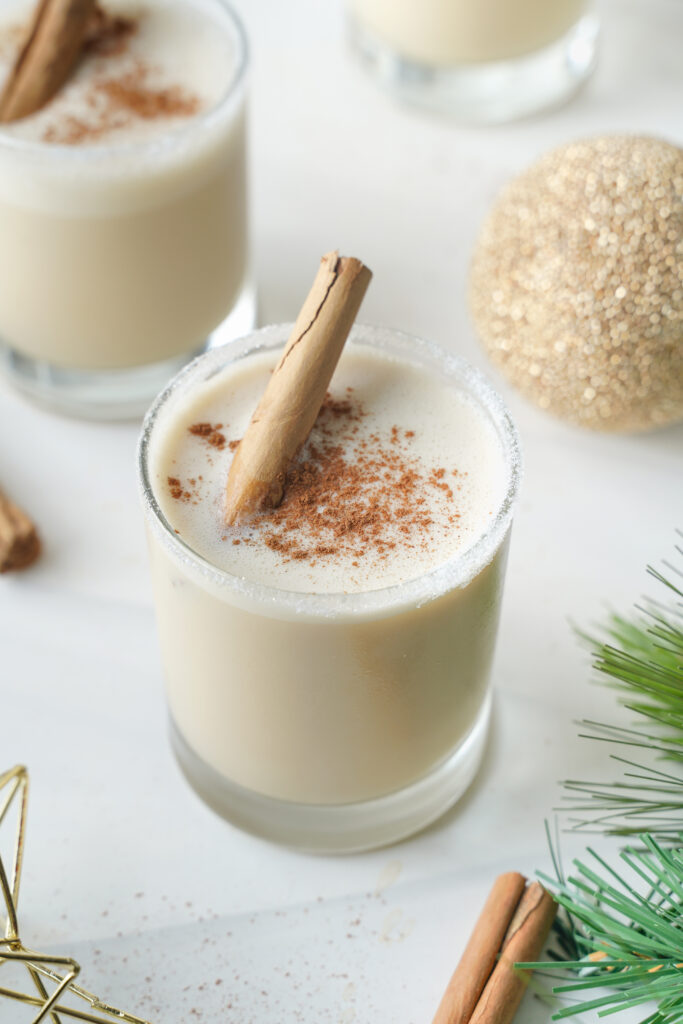 easy eggnog cocktail topped with cinnamon and a cinnamon stick