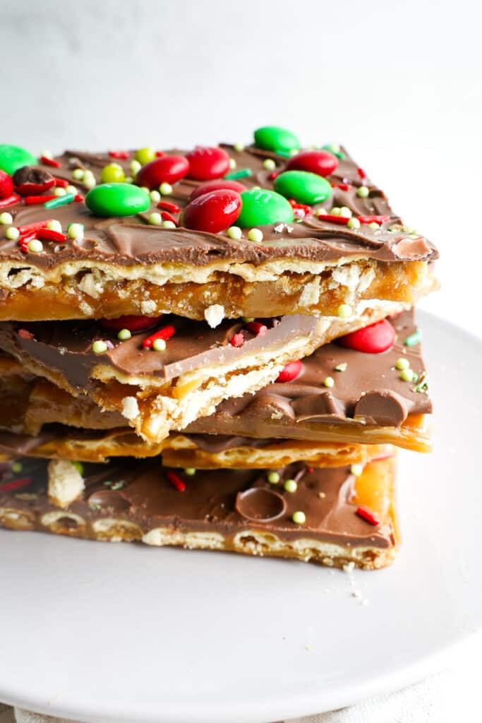Christmas crack recipe made with saltine crackers, buttery toffee, melted chocolate, and festive red and green holiday toppings