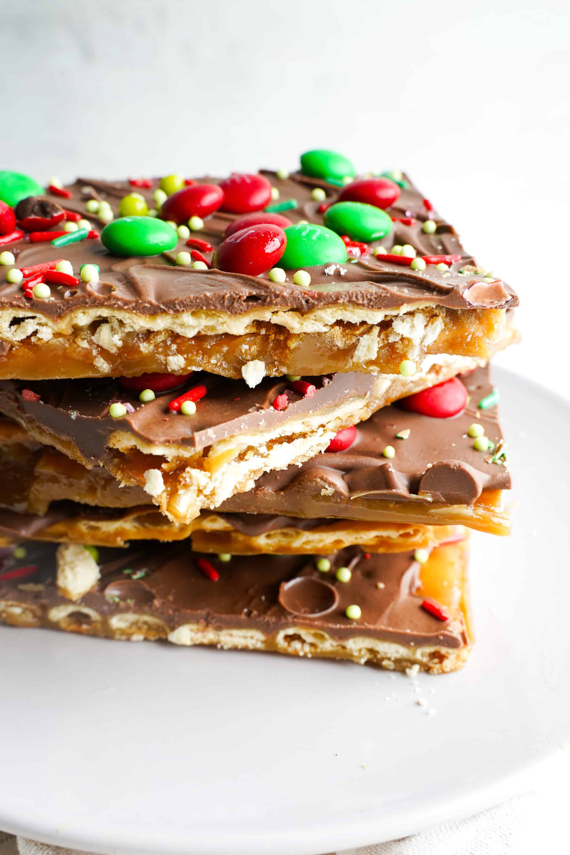 Christmas crack recipe made with saltine crackers, buttery toffee, melted chocolate, and festive red and green holiday toppings