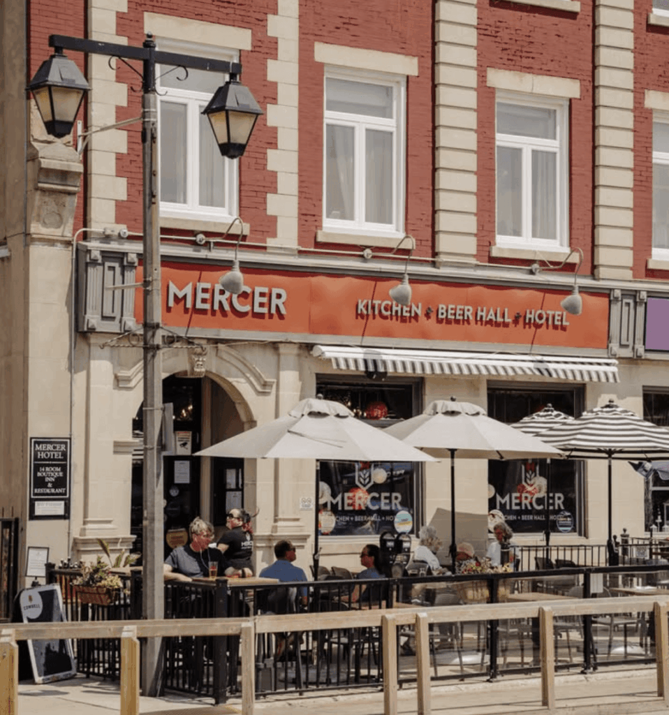 Exterior of Mercer Kitchen + Beer Hall in downtown Stratford, Ontario, with its street-side patio